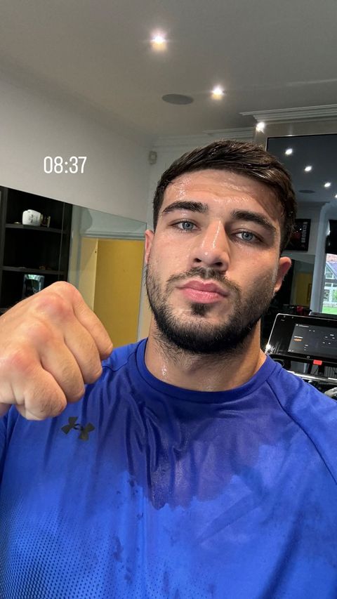 a man in a blue under armour shirt is sweating