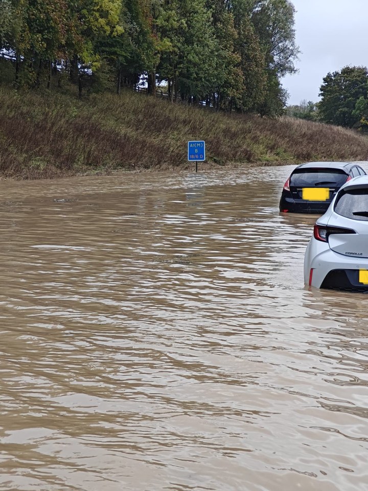 The A1 has today been completely closed after heavy rain left some cars stuck in swirling floodwater