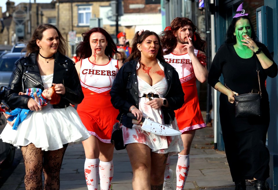 a group of cheerleaders are walking down the street