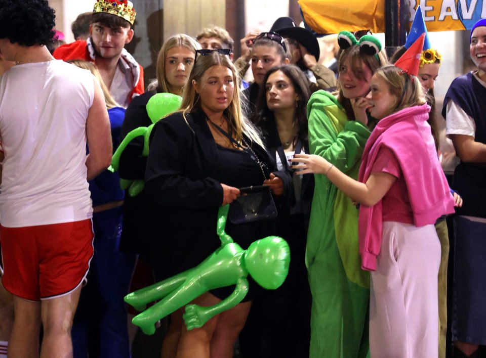 Groups of partygoers dressed as Men in Black and carried inflatable aliens