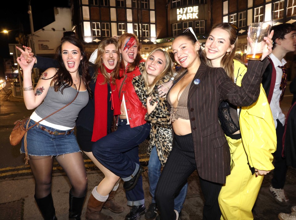 a group of women are posing for a picture in front of hyde park