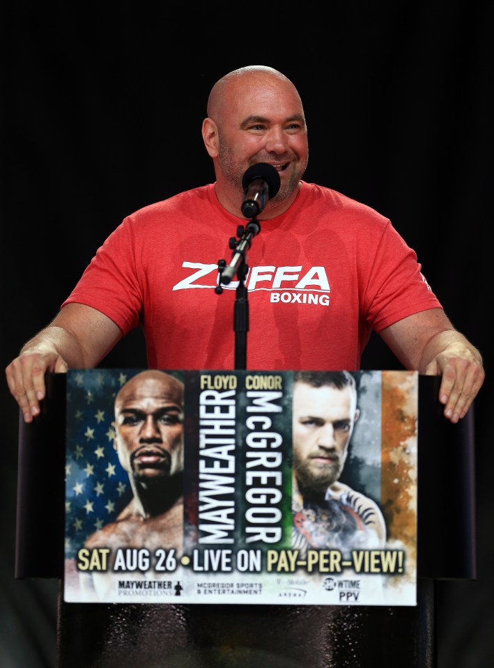 a man in a zffa boxing shirt speaks into a microphone