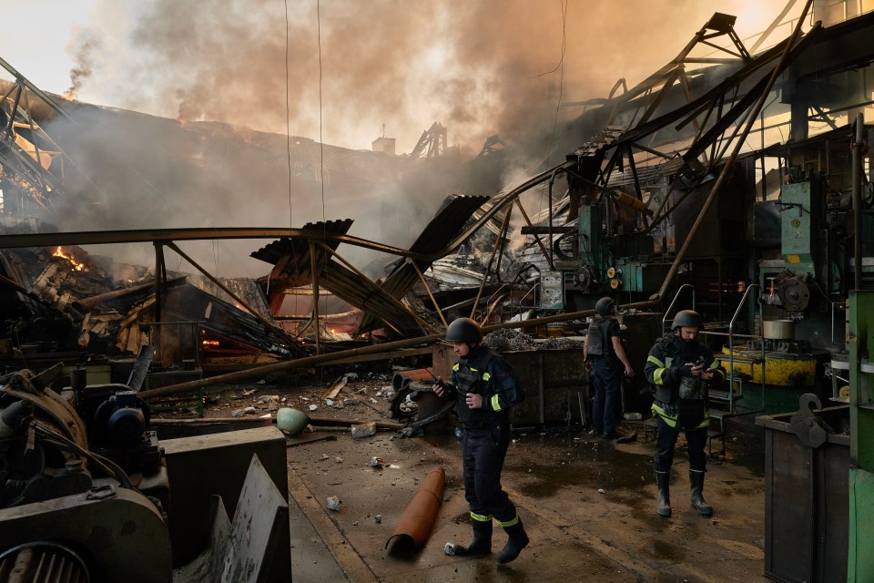 Ukrainian firefighters extinguish a fire at a factory following a Russian missile strike last week