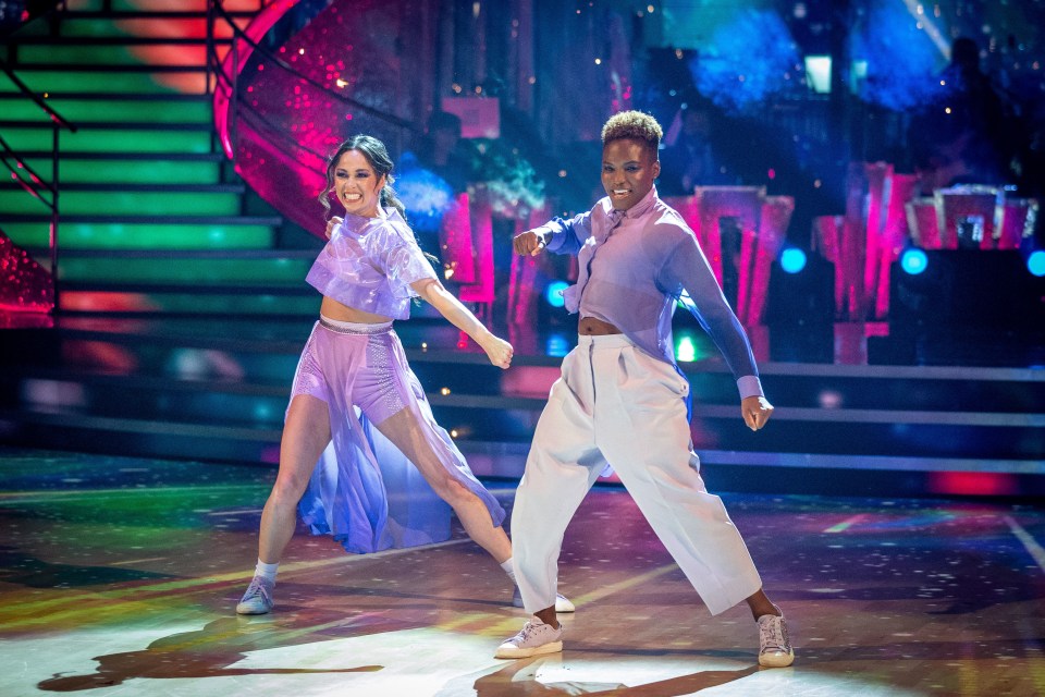 a man and a woman are dancing on a stage