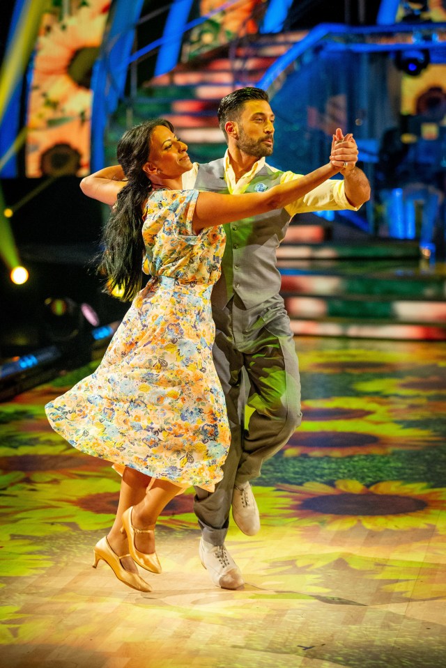 a man and a woman are dancing on a dance floor