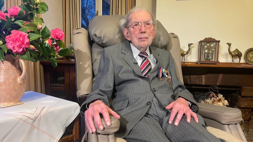 a man in a suit and tie is sitting in a chair