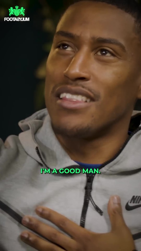 a man is wearing a grey nike jacket