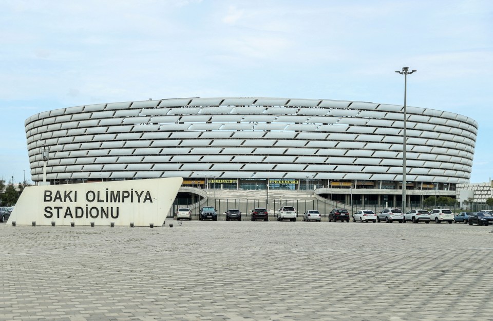 a large building with a sign that says baku olimpiya stadionu