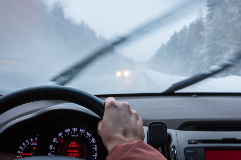 a person driving a car with a temperature of -3.5 degrees celsius