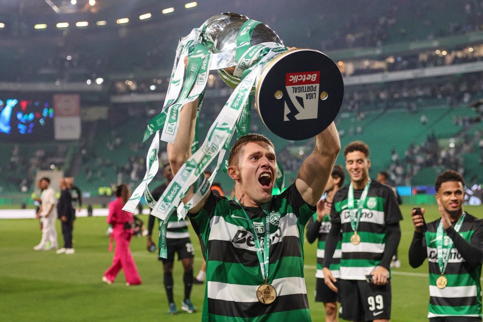 a man holding a trophy that says betvic on it