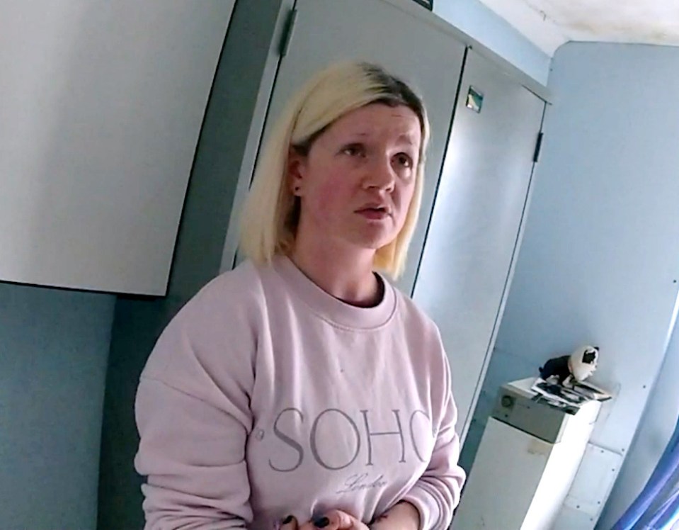 a woman wearing a sweater that says soho on it