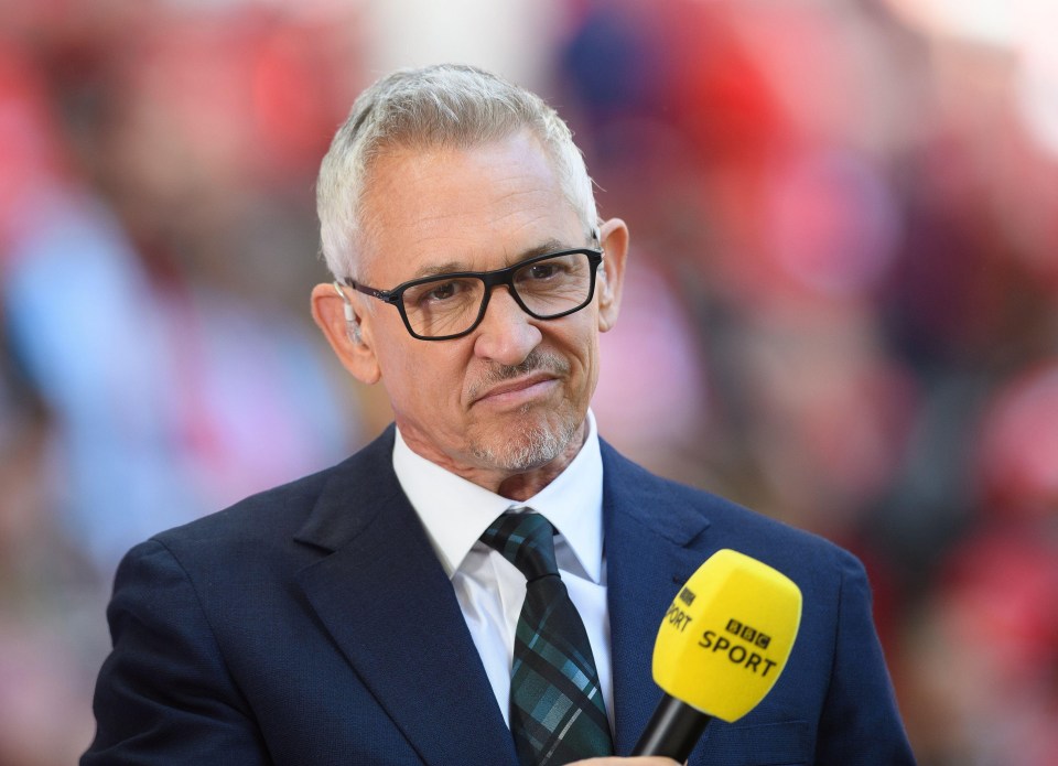 a man in a suit and tie holds a yellow bbc sport microphone