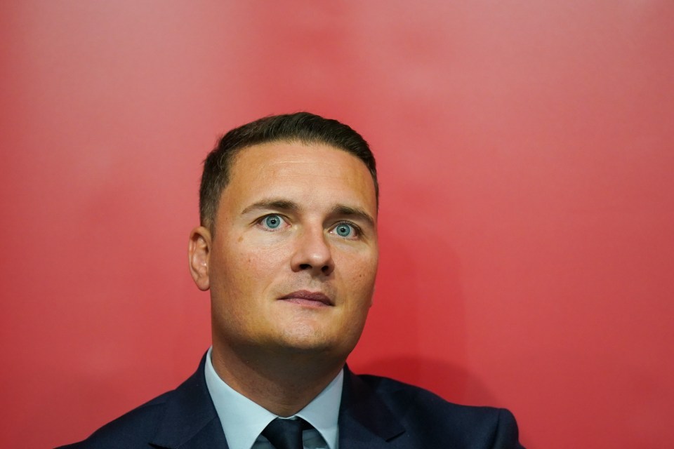 a man in a suit and tie against a red background