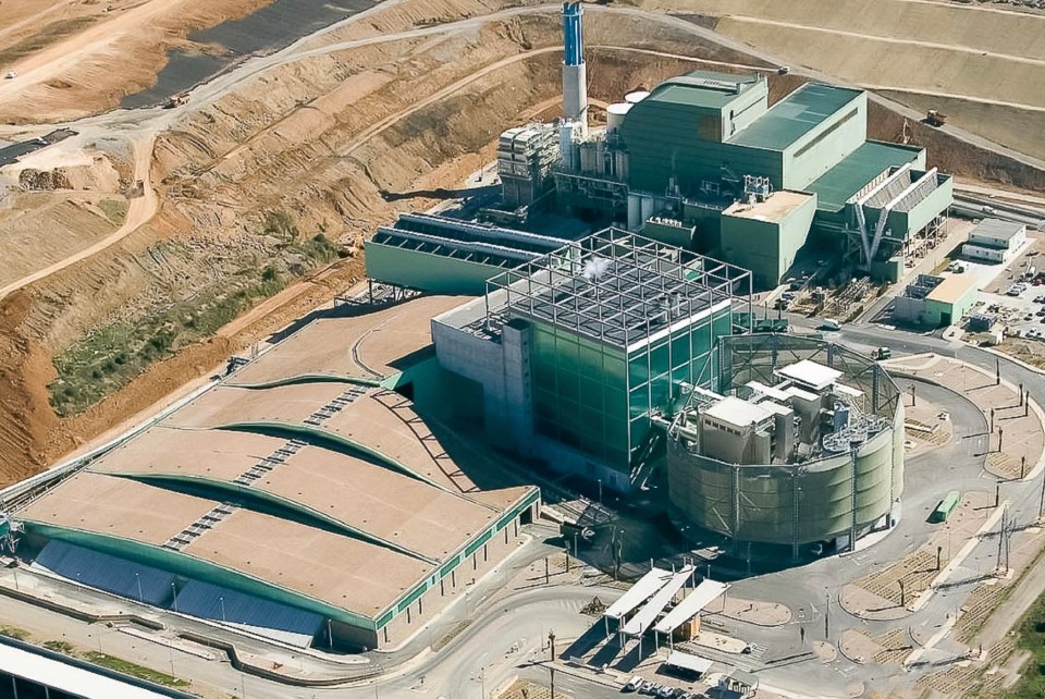 an aerial view of a large building with a green roof