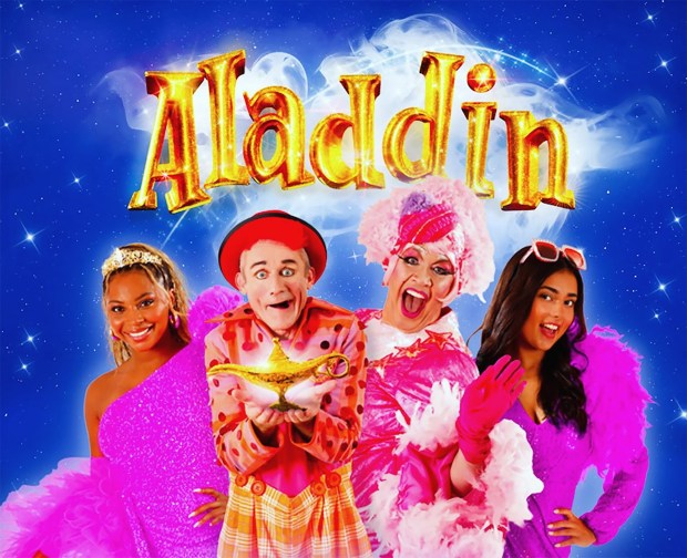 a group of people standing in front of a sign that says aladdin