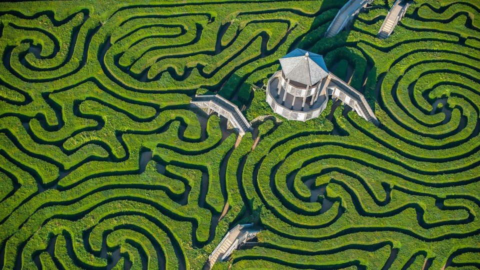 an aerial view of a maze with a tower in the middle