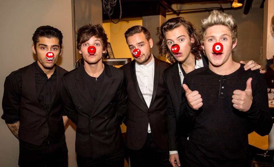 a group of men with red noses are posing for a picture