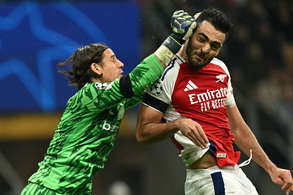 a soccer player wearing a red emirates fly better shirt