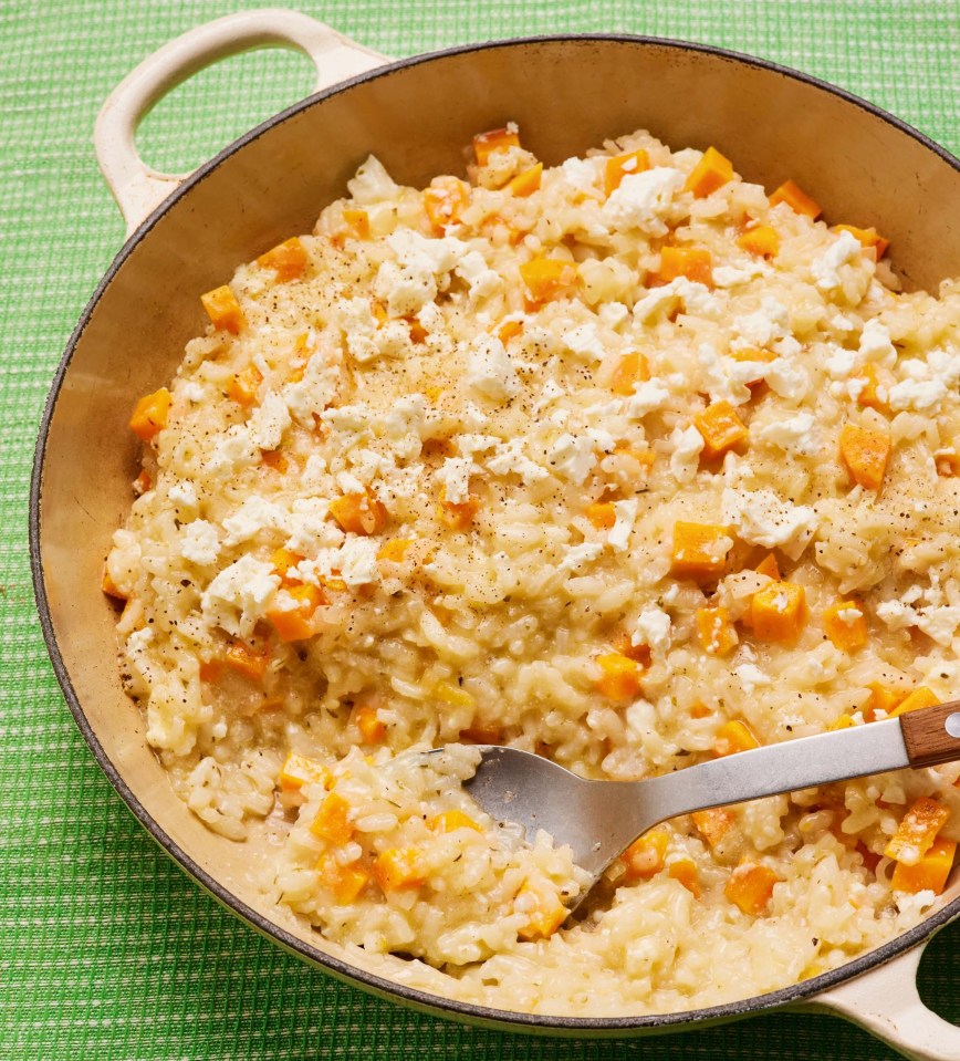 a pan of risotto with a spoon in it