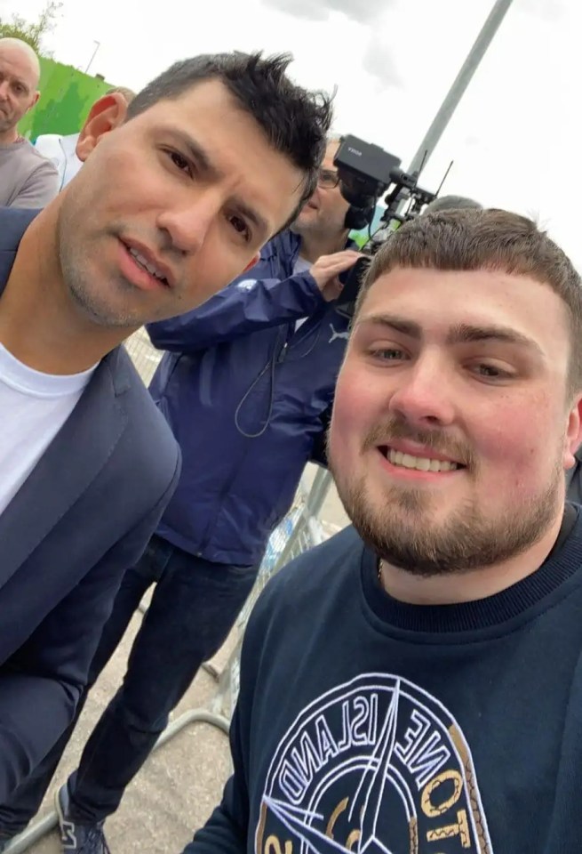 a man wearing a stone island sweatshirt poses for a photo