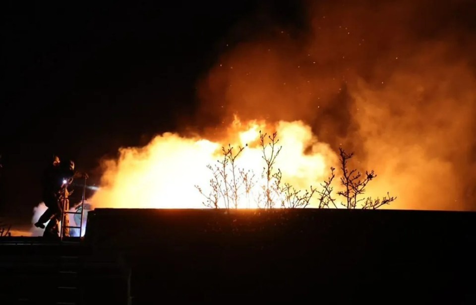 Firefighters work at the site of a Russian missile strike in Dnipro