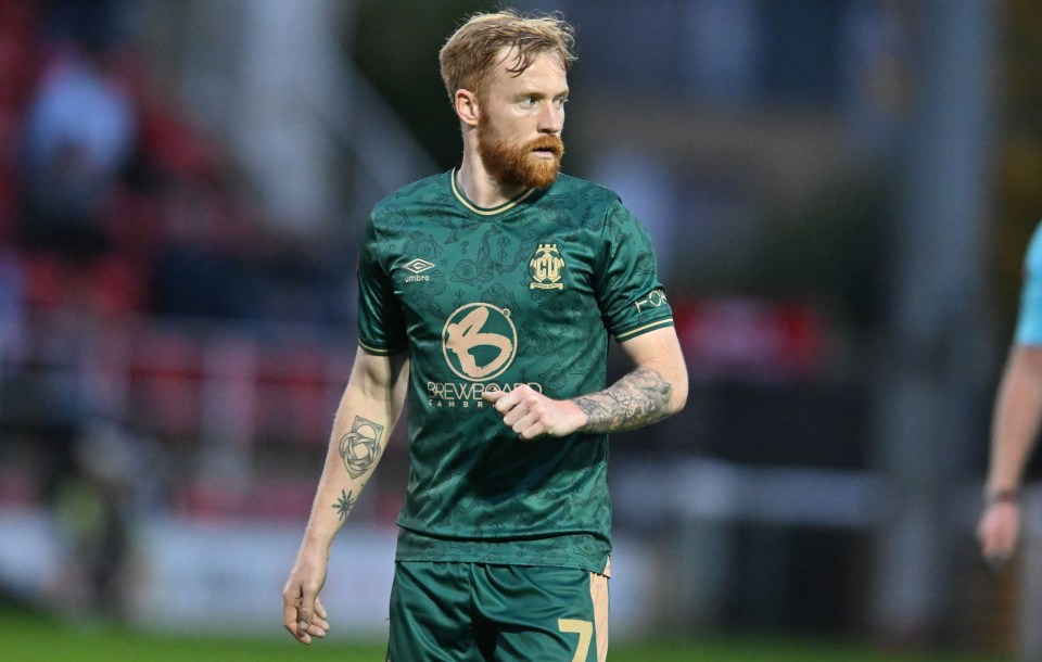 a soccer player wearing a green jersey that says brewers