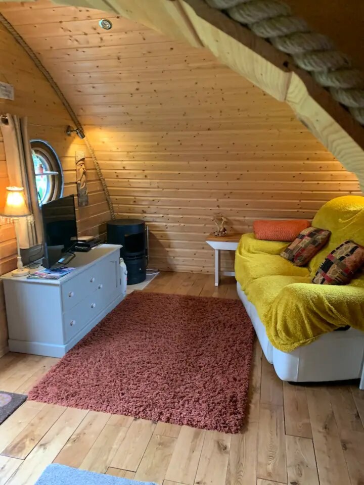 a living room with a yellow couch and a rug