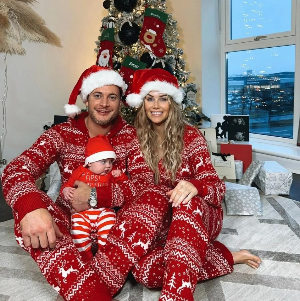 a family is posing for a picture in front of a christmas tree