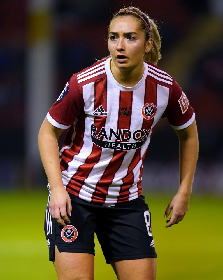 a female soccer player wearing a jersey that says randox health