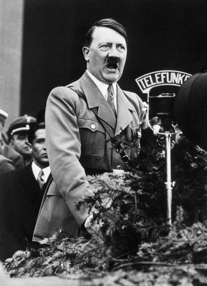 a black and white photo of a man standing in front of a sign that says telefonk