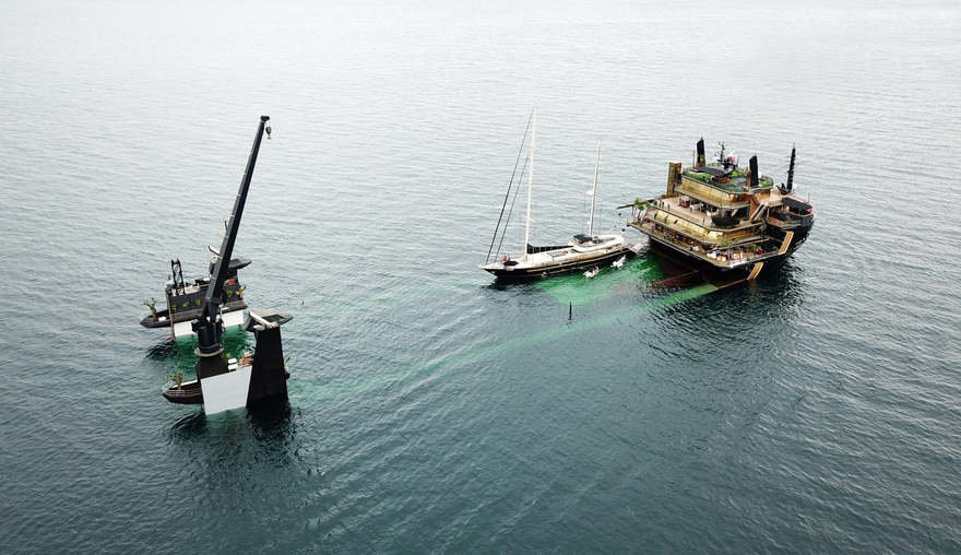 The middle of the ship completely submerses to allow on yachts