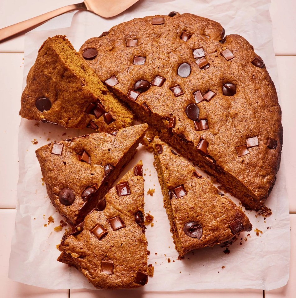 a cake with chocolate chips and a spatula next to it