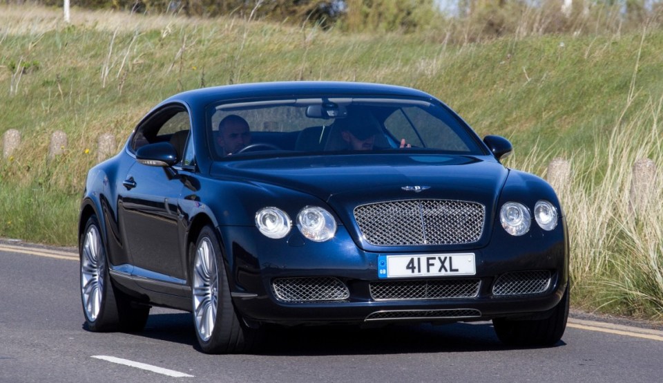 J2220R Bentley Continental GT Auto at Vintage Festival and Classic Vehicle Show, with cars driving down the resort seafront promenade, Southport, Merseyside,