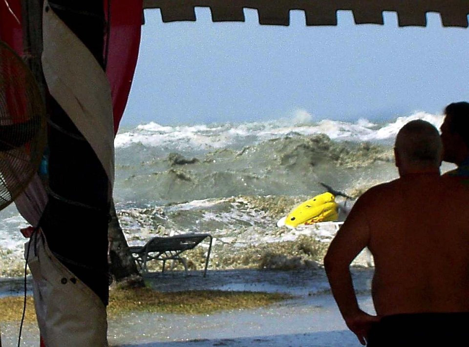 A photo by tourist Eric Skitzi shows the moment the wave hit the beach in Malaysia, down the coast from Thailand