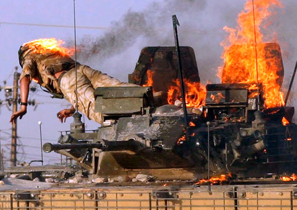 Private Karl Hinett jumps from a burning tank set ablaze in Basra on September 19, 2005