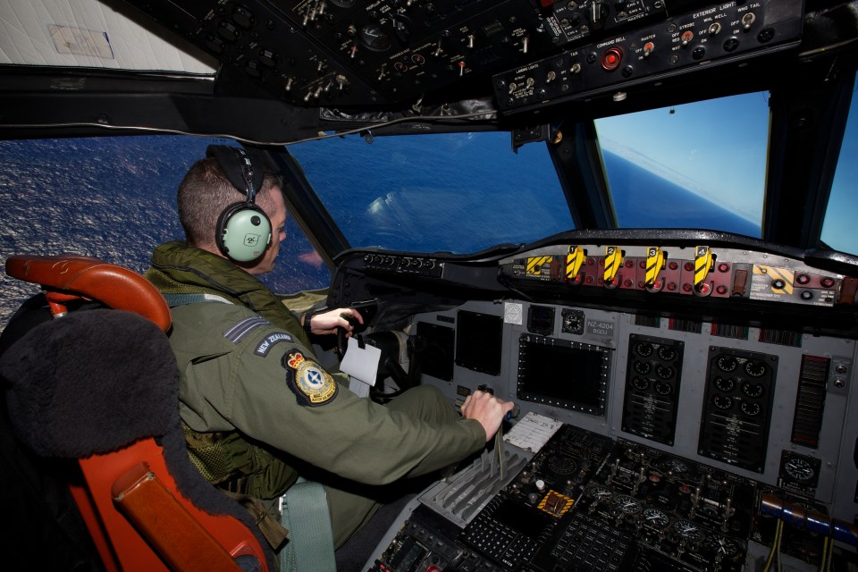 a man in a pilot 's seat with a patch on his arm that says royal canadian air force