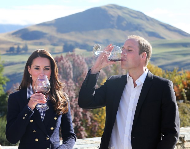 a man and woman drinking wine with a mountain in the background