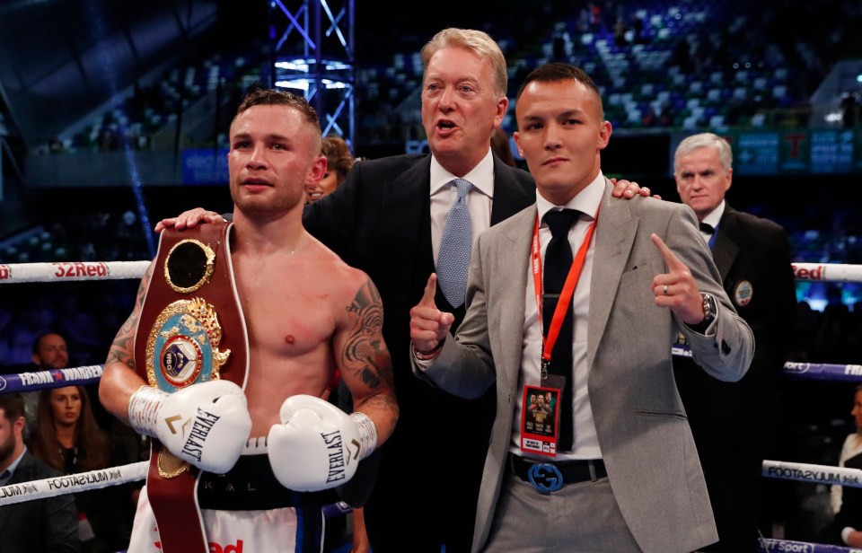 a man wearing everlast boxing gloves stands in a boxing ring