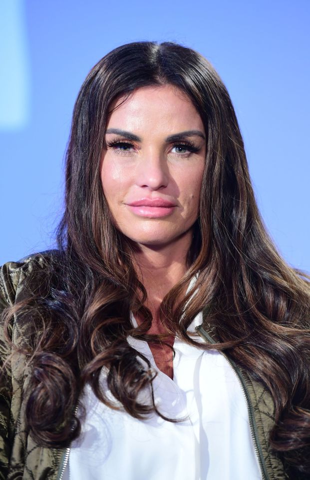 a woman with long dark hair is wearing a white shirt and a green jacket