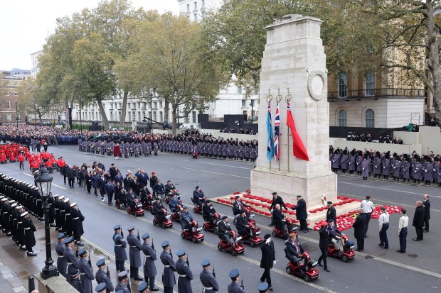 a group of people standing in front of a monument