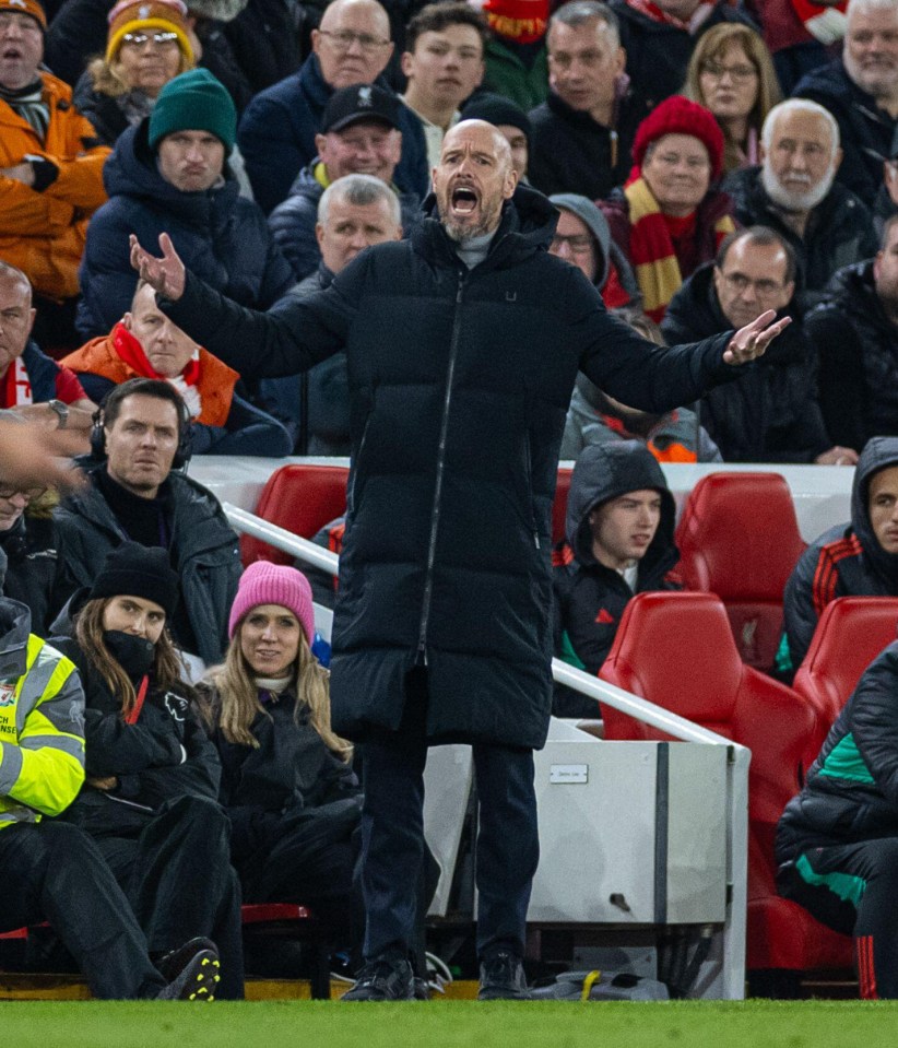 a man in a black jacket shouts at a crowd of people