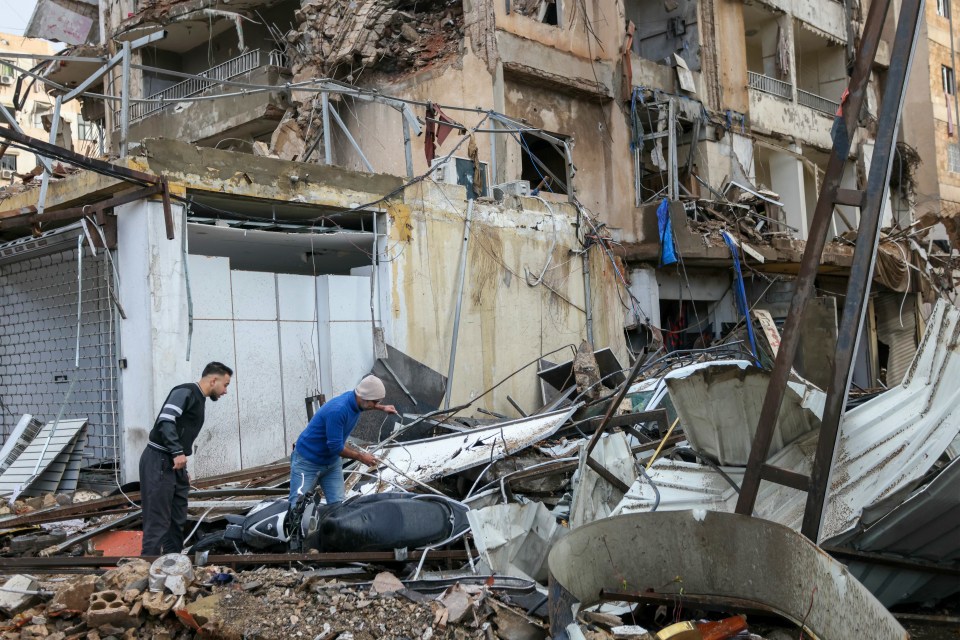 People inspect the damage at the site of an overnight Israeli airstrike that targeted the Chayah neighborhood in Beirut’s southern suburbs