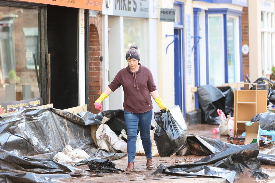 People cleaning up after the flooding in Tenbury Wells