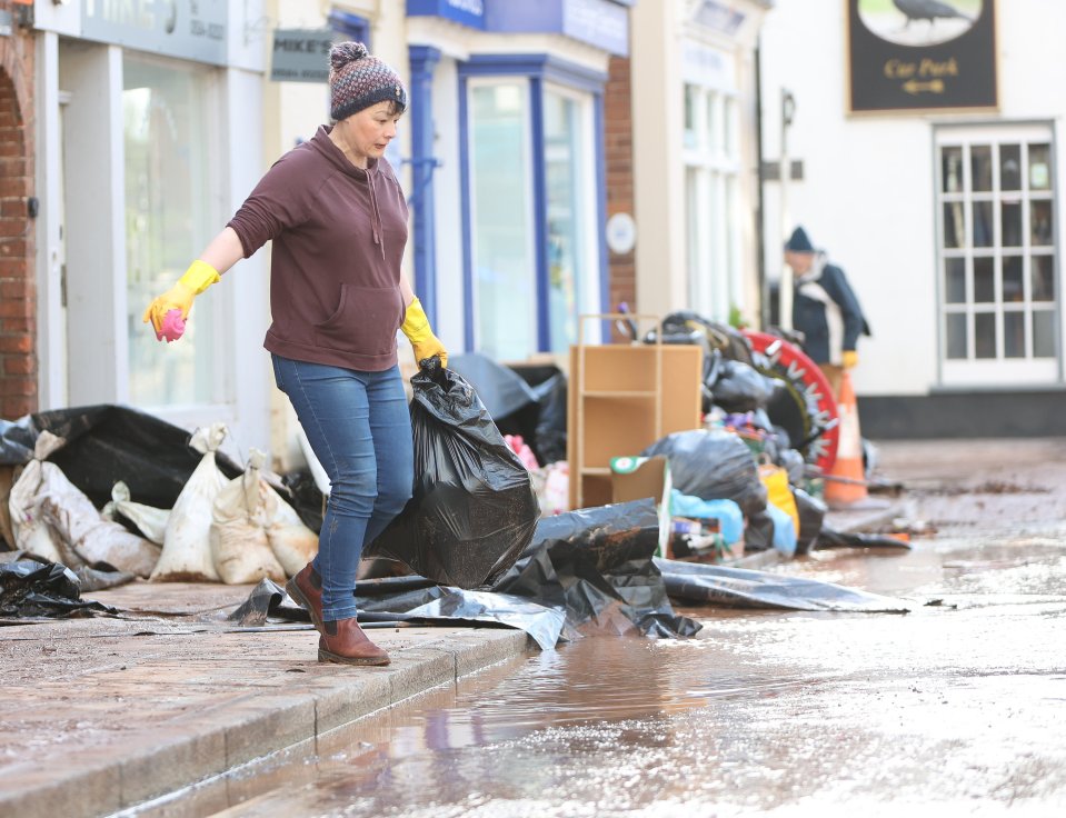 People cleaning up after the flooding in Tenbury Wells