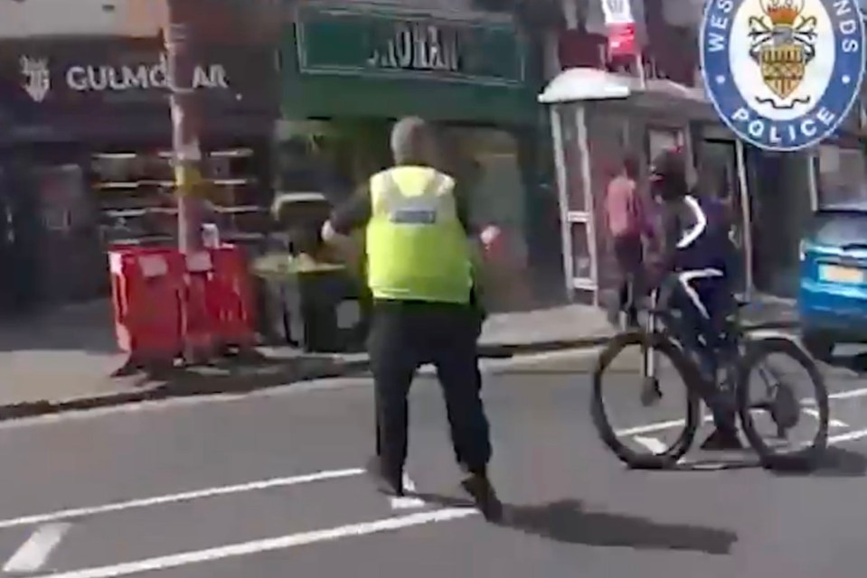 An officer for West Midlands Police is seen standing in Balu’s path as he speeds down the street