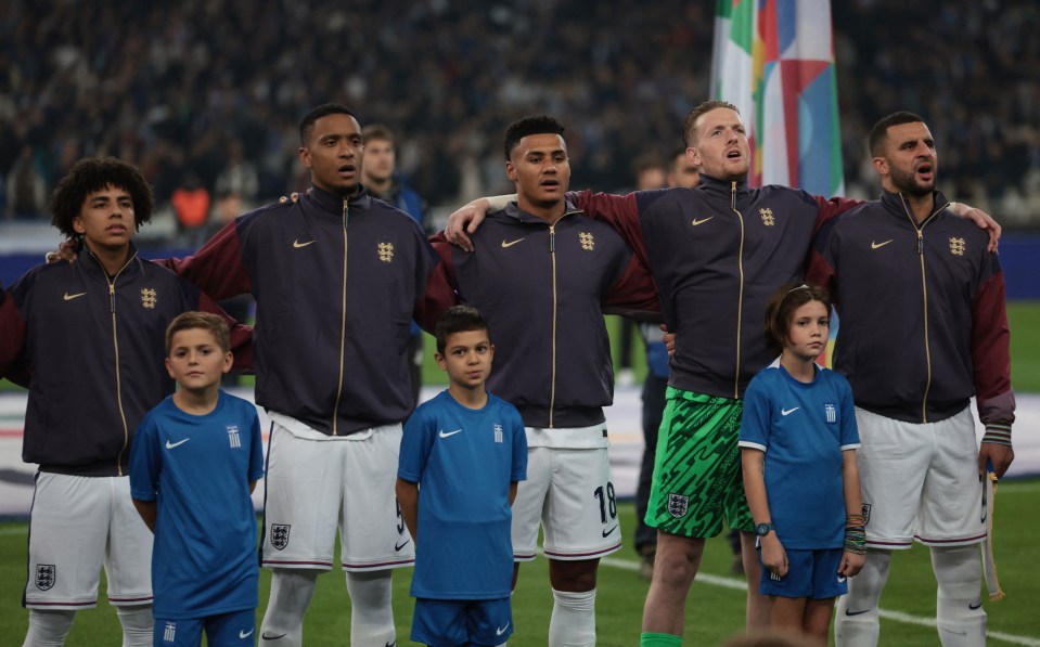 a group of soccer players are standing on a field and one has the number 18 on his shorts