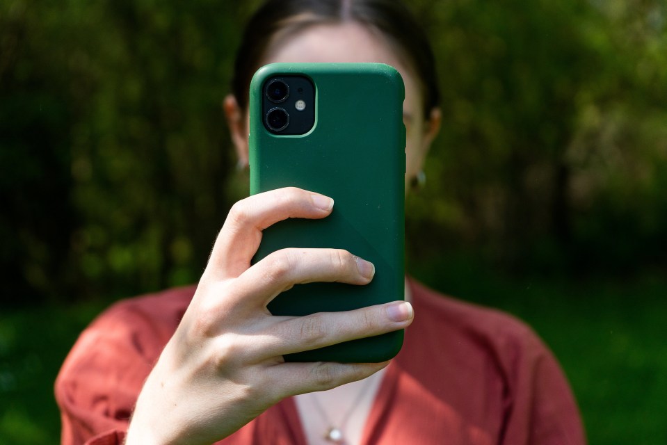 a woman is taking a picture of herself with her phone