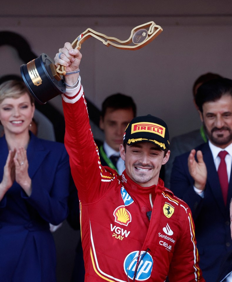 a man holding up a trophy that says irelli on it