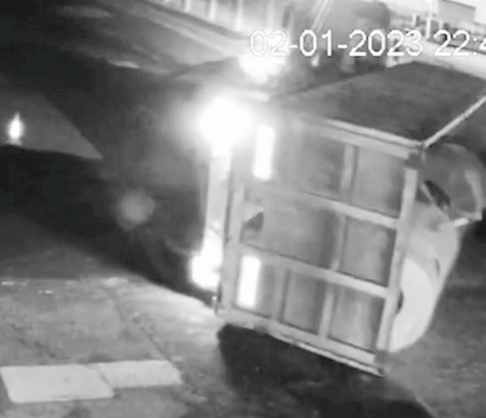 a black and white photo of a dumpster on its side .