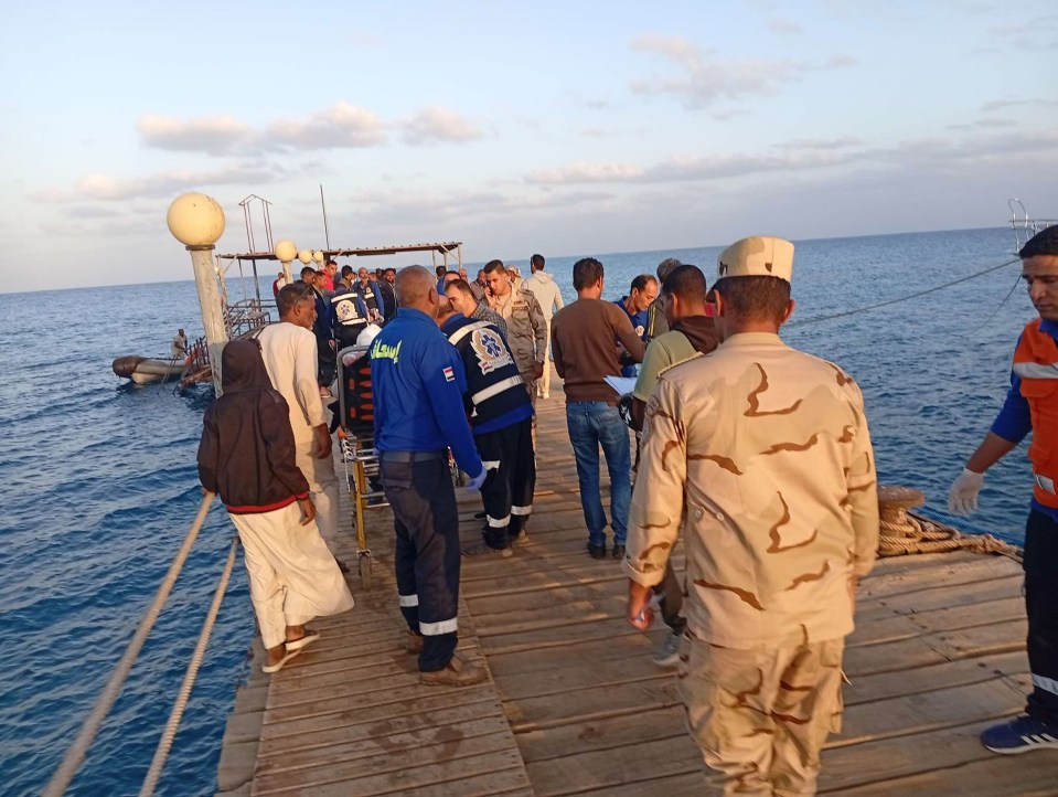 Rescuers work near the site where a boat sank in the Red Sea, in Marsa Alam, Egypt